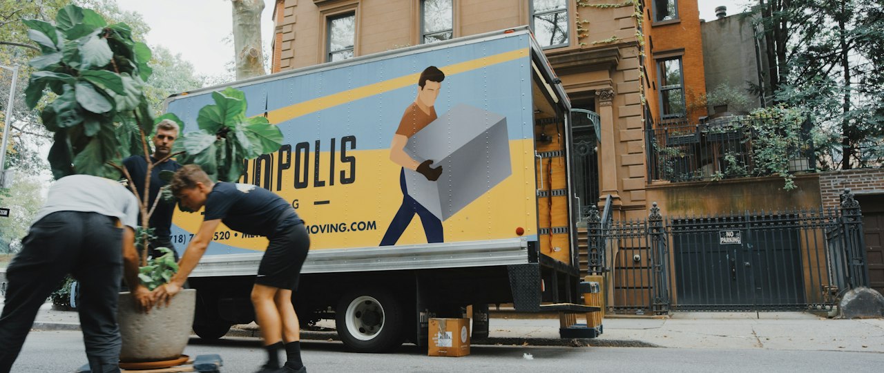 Stacked moving boxes in a room, representing the packing stage after decisions are made
